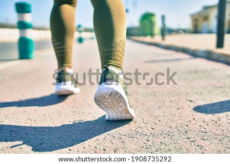 Sportswoman wearing sportswear running at the city.