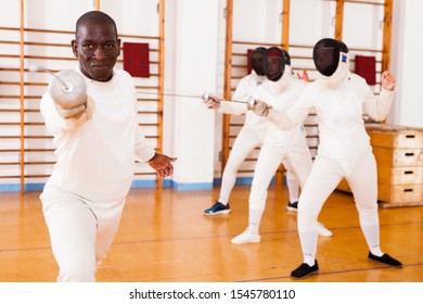 Sporty african american man fencer practicing effective fencing techniques in training room 



 - Powered by Shutterstock