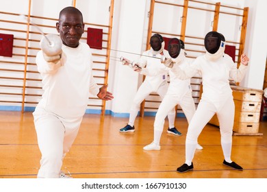 Sporty african american man fencer practicing effective fencing techniques in training room 



 - Powered by Shutterstock