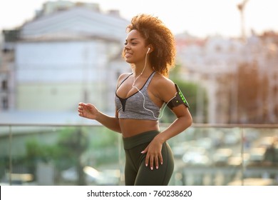 Sporty African American Woman Running Outdoors