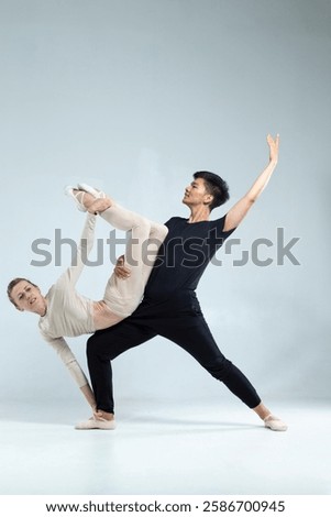 Similar – Image, Stock Photo Vertical composition. Ballerina in the studio at rehearsal. Spotlights and fog in blue tones. Sexually. No face