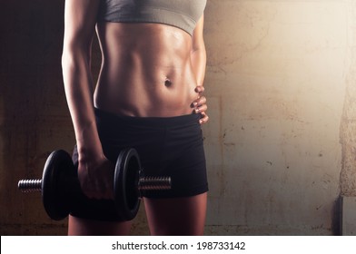 Sporty Athletic Woman Ready For Hard Training With Dumbbells