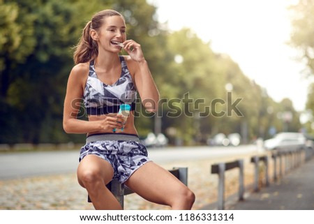 Similar – Happy fit woman taking a break from jogging