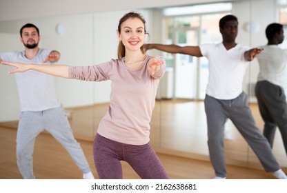 Sporty Attractive Young Woman Enjoying Latin Dances In Modern Studio, Practicing Passionate Samba During Group Class..