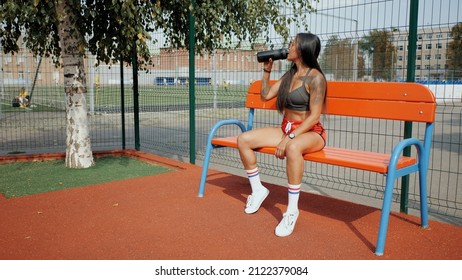 Sporty Beautiful Woman Drinks Water After Running In Slow Motion, Quenches Thirst After Training On The Sports Ground In Hot Summer