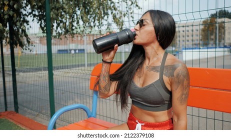 Sporty Beautiful Woman Drinks Water After Running In Slow Motion, Quenches Thirst After Training On The Sports Ground In Hot Summer