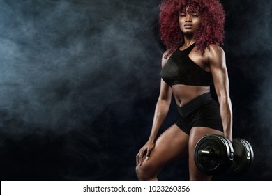 Sporty Beautiful Woman With Dumbbells Makes Fitness Exercising At Black Background To Stay Fit