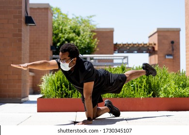 Sporty black man exercises on urban city rooftop during coronavirus pandemic quarantine.  African American man does Yoga for health and fitness during global covid-19 virus lockdown.  - Powered by Shutterstock