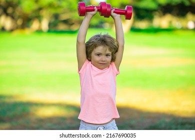 Sporty Boy With Dumbbells Outdoor. Fitness Kids, Health And Energy. Healthy Kids Lifestyle. Kid Exercising With Dumbbell. Sport For Little Children. Sport Portrait Kids.