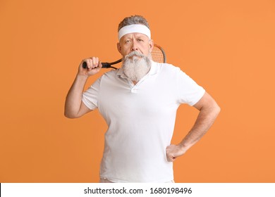 Sporty Elderly Tennis Player On Color Background