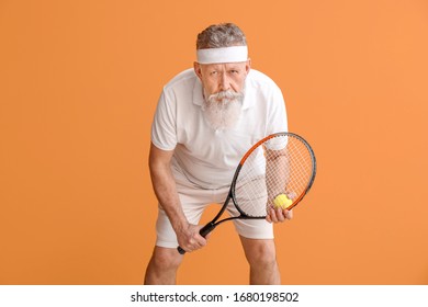 Sporty Elderly Tennis Player On Color Background