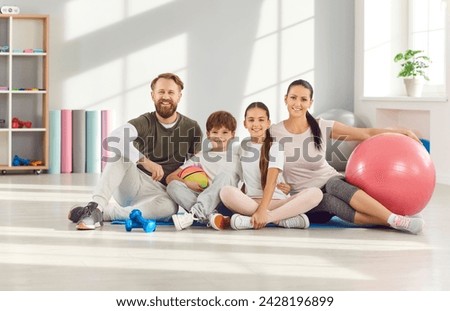 Sporty family group portrait, young sporty happy people, parents and children posing in fitness club. Active team, athletic friend exercise, healthy sport recreational activity together, balance work