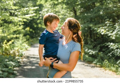 A Sporty Family Mothe And Son Outside In Forest