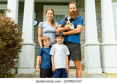 A Sporty Family Together In Front Of The House Door