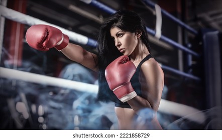 Sporty Female Boxer Training In Gym