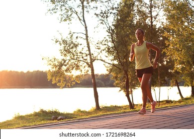 Sporty Female Jogger Running And Training Outside In Nature.