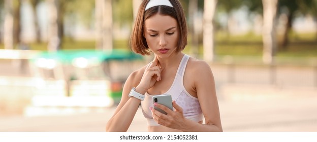 Sporty female runner checking pulse outdoors - Shutterstock ID 2154052381