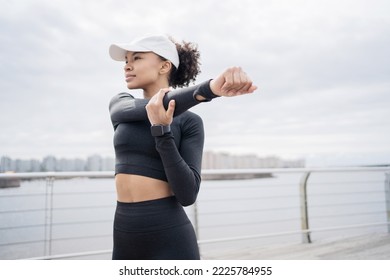 A Sporty Female Runner Uses A Fitness Watch For Training.