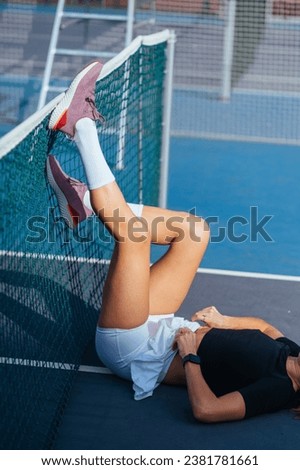 Similar – Young woman stretching legs before training outdoors