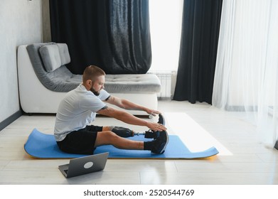 Sporty fit young man amputee with prosthetic leg disability prosthesis doing plank exercise on mat at home. Inclusive sport training for people with disabilities concept. Close up shot - Powered by Shutterstock