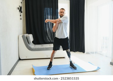 Sporty fit young man amputee with prosthetic leg disability prosthesis doing plank exercise on mat at home. Inclusive sport training for people with disabilities concept. Close up shot - Powered by Shutterstock