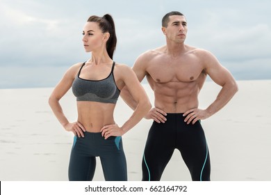 Sporty Fitness Couple Showing Muscle Outdoors. Beautiful Athletic Man And Woman, Muscular Torso Abs