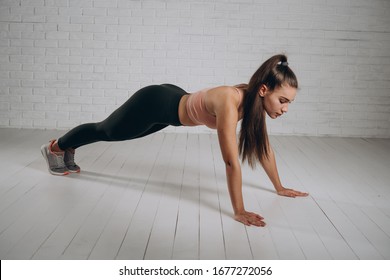 Sporty Girl Is Doing Fitness Exercises. Girl Doing Push-ups. Total Body Workout.