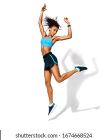 Sporty girl jumping up in silhouette. Photo of african american girl in fashionable sportswear on white background. Dynamic movement. Side view. Full length. Sports and healthy lifestyle