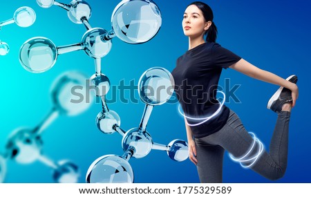 Sporty girl posing among glassy molecules. Good metabolism concept. Over blue background.