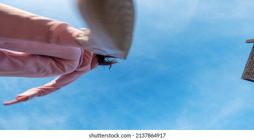 Sporty Girl Running In Pink Sports Suit Under The Summer Sun Sky And Jumping Over Camera, View From Below, Copy Space