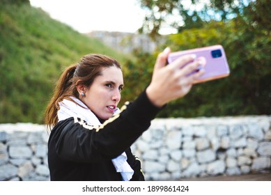 Sporty Girl Taking A Self Portrait Photography At Park.