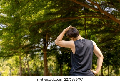 sporty handsome man stretching neck and head after jogging in city public park during summer day, young guy spend quality time on weekend workout outdoor in nature for healthy and active lifestyle - Powered by Shutterstock