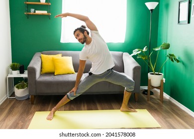 Sporty Happy Young Man In A Warrior Yoga Pose. Latin Man Relaxing With