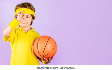 Sporty kid boy with basketball ball showing okay sign. Sport for children. Little basketball player.