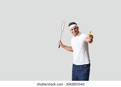 Sporty Male Badminton Player On Light Background