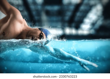 Sporty man athlete swims with energy during a competition in the pool