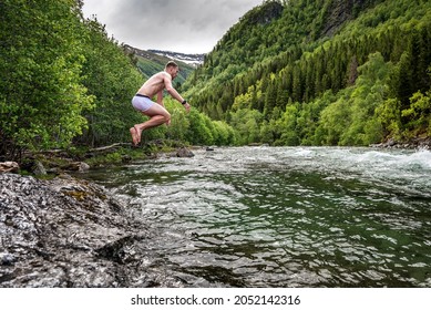 Sporty Man Jumping Into Cold Mountain River