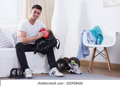 Sporty Man Packing Protein Powder To The Bag