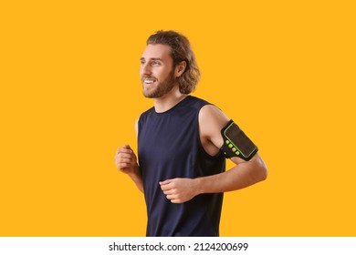 Sporty Man Running On Color Background