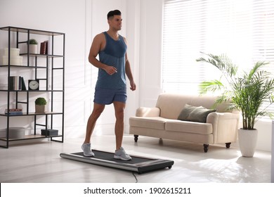 Sporty Man Training On Walking Treadmill At Home