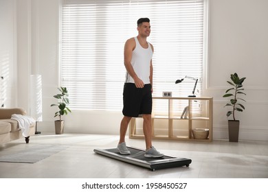 Sporty Man Training On Walking Treadmill At Home