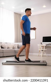 Sporty Man Training On Walking Treadmill At Home