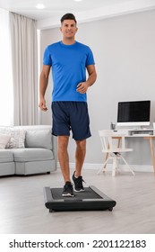 Sporty Man Training On Walking Treadmill At Home