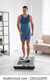 Sporty Man Training On Walking Treadmill At Home