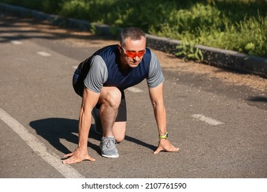 Sporty Mature Man Getting Ready To Run On Road