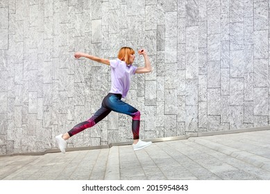 Sporty mature woman jogging through town running up an incline past commercial buildings in a healthy active outdoors lifestyle and fitness concept - Shutterstock ID 2015954843