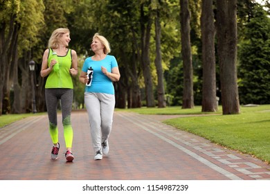 Sporty Mature Women Training In Park