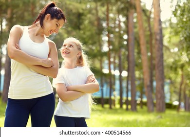 Sporty Mother And Daughter. Woman And Child Training In The Park. Outdoor Sports And Fitness. Healthy Sport Lifestyle