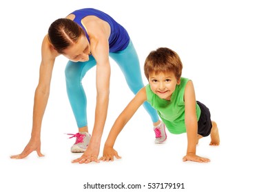 Sporty mother doing pushing ups with her kid son - Powered by Shutterstock