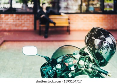 A sporty motorcycle parked in front of a coffee shop - Powered by Shutterstock